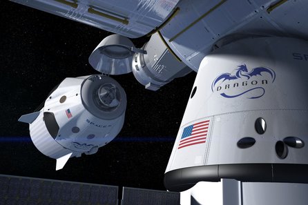 Pilotovaná loď Crew Dragon se blíží ke stanici ISS, kde je připojen nákladní Dragon (umělecká představa, wikimedia.org)